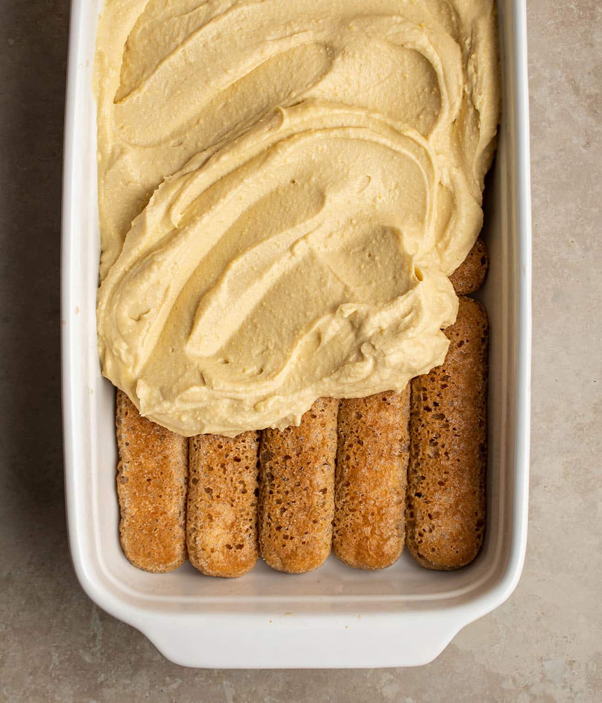 spread filling on soaked ladyfingers
